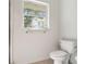Simple bathroom with toilet and a window at 13080 Old Crystal River Rd, Brooksville, FL 34601