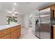 Kitchen with stainless steel refrigerator and access to backyard at 13080 Old Crystal River Rd, Brooksville, FL 34601