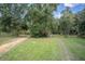 Gravel driveway leading through a wooded area at 13080 Old Crystal River Rd, Brooksville, FL 34601