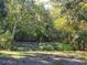 Metal gate entrance to a private wooded area at 13080 Old Crystal River Rd, Brooksville, FL 34601