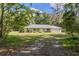 Single-story house with metal roof and large yard at 13080 Old Crystal River Rd, Brooksville, FL 34601