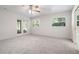 Bedroom with carpeted floors, ceiling fan and sliding glass doors at 13080 Old Crystal River Rd, Brooksville, FL 34601