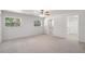 Spacious bedroom with carpet flooring, ceiling fan, and walk-in closet at 13080 Old Crystal River Rd, Brooksville, FL 34601