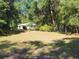 Ranch-style home nestled in a wooded area at 13080 Old Crystal River Rd, Brooksville, FL 34601