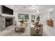 Inviting living room with stone fireplace and large window overlooking the backyard at 13080 Old Crystal River Rd, Brooksville, FL 34601