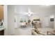 Bright, neutral living space with large window, bench seat, and a ceiling fan at 13080 Old Crystal River Rd, Brooksville, FL 34601