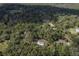 Aerial view showing a house nestled in a wooded area at 13080 Old Crystal River Rd, Brooksville, FL 34601