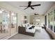 Spacious screened-in patio with ceiling fans, comfortable seating, and a view of the backyard at 13080 Old Crystal River Rd, Brooksville, FL 34601