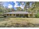 Back of house featuring a metal roof and screened porch at 13080 Old Crystal River Rd, Brooksville, FL 34601