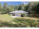 Ranch-style home with metal roof, screened porch, and large yard at 13080 Old Crystal River Rd, Brooksville, FL 34601