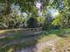 Metal gate entrance to a private wooded area at 13080 Old Crystal River Rd, Brooksville, FL 34601