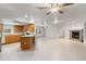 Spacious living room with tile floors, a fireplace and kitchen access at 13080 Old Crystal River Rd, Brooksville, FL 34601