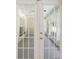 White French doors open to a screened porch with a view of the backyard at 13080 Old Crystal River Rd, Brooksville, FL 34601