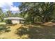 Spacious backyard with large trees and grassy area at 13080 Old Crystal River Rd, Brooksville, FL 34601