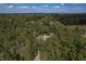 Aerial view showing a house nestled in a lush forest setting at 13080 Old Crystal River Rd, Brooksville, FL 34601