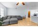Living room with grey sectional sofa and tile floors at 13242 Little Farms Dr, Spring Hill, FL 34609