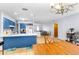 Bright kitchen features blue cabinets, ample counter space, and a view into the living area at 13242 Little Farms Dr, Spring Hill, FL 34609