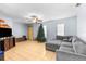 Living room with grey sectional sofa and tile floors at 13242 Little Farms Dr, Spring Hill, FL 34609