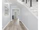 View of a modern staircase with white risers and black railing at 14485 Switch Back Rd, Brooksville, FL 34609