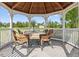 Wicker furniture and a table set inside a gazebo at 14485 Switch Back Rd, Brooksville, FL 34609