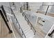 Grand staircase with marble steps and modern metal railings at 14485 Switch Back Rd, Brooksville, FL 34609