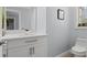 Small modern bathroom with white vanity, quartz countertop and toilet at 14485 Switch Back Rd, Brooksville, FL 34609