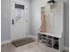 Entryway with shoe storage bench, coat hooks and a white door at 14485 Switch Back Rd, Brooksville, FL 34609
