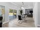 Dining room with backyard view, a modern chandelier, and an elegant glass table at 14485 Switch Back Rd, Brooksville, FL 34609
