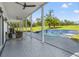 Relaxing pool area with covered patio, seating and waterfall feature at 14485 Switch Back Rd, Brooksville, FL 34609