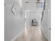 Light and airy hallway with modern decor, high ceilings, and wood floors at 14485 Switch Back Rd, Brooksville, FL 34609