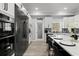 Modern kitchen with stainless steel appliances, a pantry, and a spacious island with bar seating at 14485 Switch Back Rd, Brooksville, FL 34609