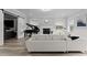 Bright living room features a fireplace, piano, and modern white furniture at 14485 Switch Back Rd, Brooksville, FL 34609
