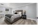 Spacious bedroom with gray bedding and a view of the backyard at 14485 Switch Back Rd, Brooksville, FL 34609