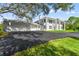 Two-story white house with attached garage and long driveway at 14485 Switch Back Rd, Brooksville, FL 34609