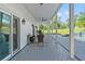 Covered patio with seating overlooking the pool and backyard at 14485 Switch Back Rd, Brooksville, FL 34609