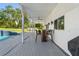 Covered patio with seating overlooking the pool and backyard at 14485 Switch Back Rd, Brooksville, FL 34609
