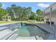 Resort-style pool with waterfall feature and covered patio at 14485 Switch Back Rd, Brooksville, FL 34609