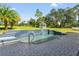 Resort-style pool with waterfall feature and spacious paver deck at 14485 Switch Back Rd, Brooksville, FL 34609