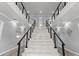 Modern staircase with marble steps, sleek railings, and stylish decor at 14485 Switch Back Rd, Brooksville, FL 34609