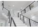 Modern staircase with marble steps and cable railings at 14485 Switch Back Rd, Brooksville, FL 34609