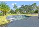 Resort-style pool with waterfall feature and spacious paver deck at 14485 Switch Back Rd, Brooksville, FL 34609