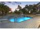 Inviting pool with a waterfall and gazebo in the background at 14485 Switch Back Rd, Brooksville, FL 34609
