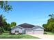 Two-car garage, light grey elevation at 16855 Castoro Dr, Port Charlotte, FL 33953