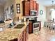 Modern kitchen with granite countertops and stainless steel appliances at 18430 Waydale Loop, Hudson, FL 34667