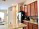 Functional kitchen with granite countertops and stainless steel appliances at 18430 Waydale Loop, Hudson, FL 34667