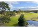 Stunning aerial view of lush green golf course with pond and trees at 1942 Golfview Dr # 1942, Tarpon Springs, FL 34689