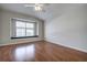 Bright bedroom with wood floors, ceiling fan, and window seat at 20743 Nectarine Pl, Land O Lakes, FL 34637