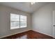 Well-lit bedroom featuring hardwood floors and a large window at 20743 Nectarine Pl, Land O Lakes, FL 34637