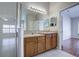 Double vanity bathroom with shower and access to bedroom at 20743 Nectarine Pl, Land O Lakes, FL 34637