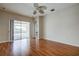 Living room with hardwood floors, sliding doors to patio, and a ceiling fan at 20743 Nectarine Pl, Land O Lakes, FL 34637